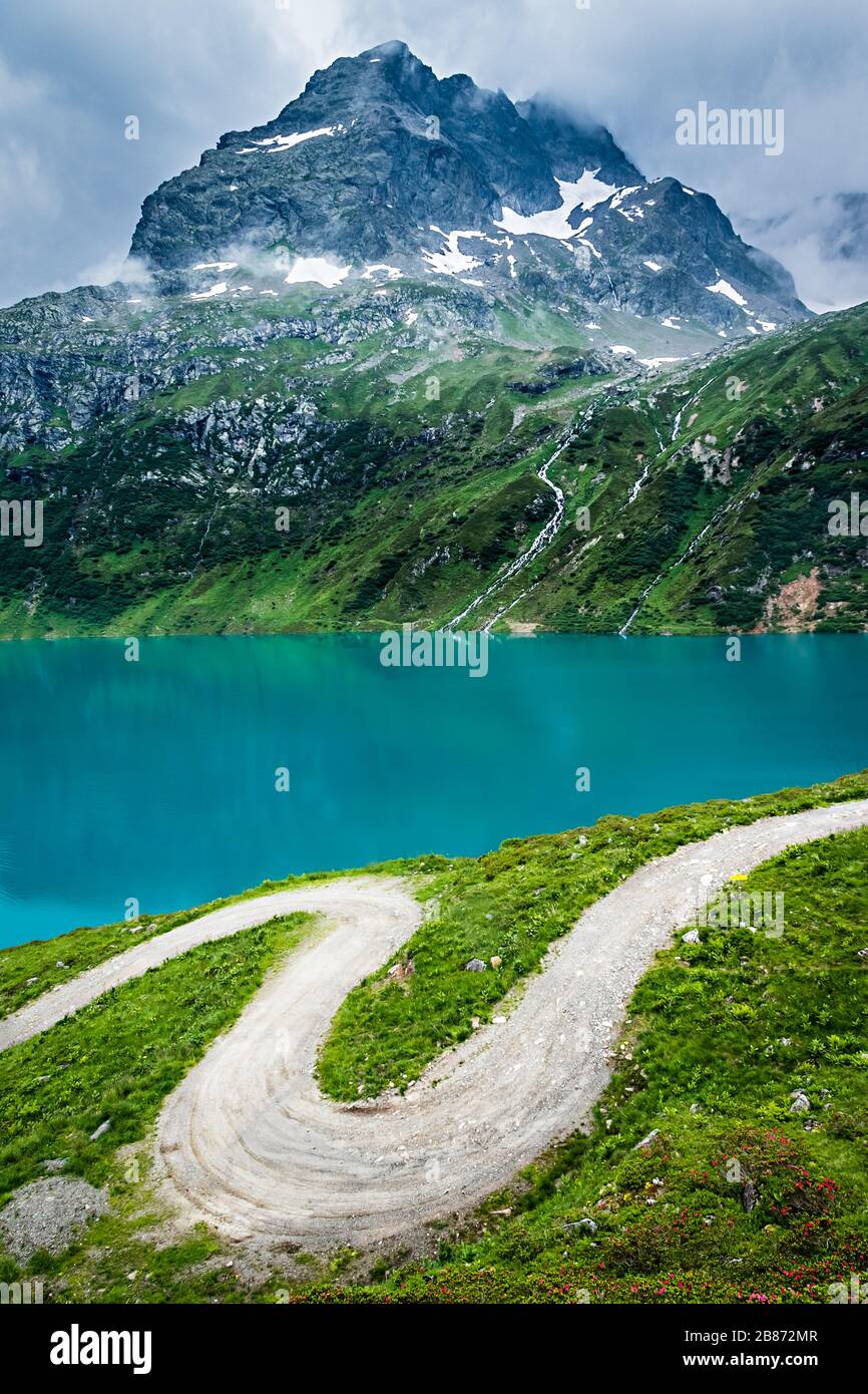 Winding Path in the Alps with a Mountain in the Background Stock Photo