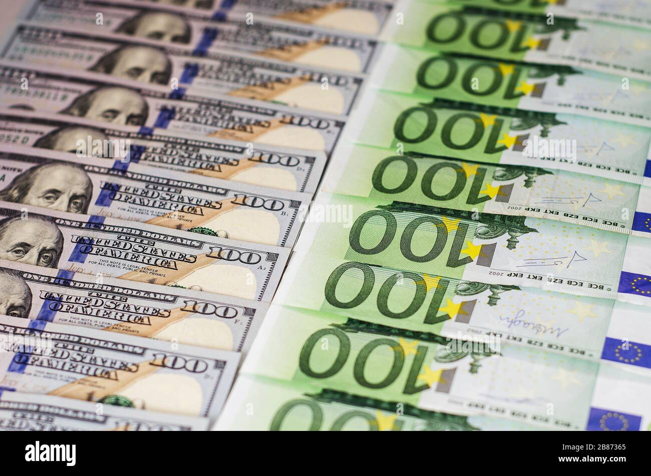 hundred dollar bills and bills of one hundred euros beautifully laid out Stock Photo