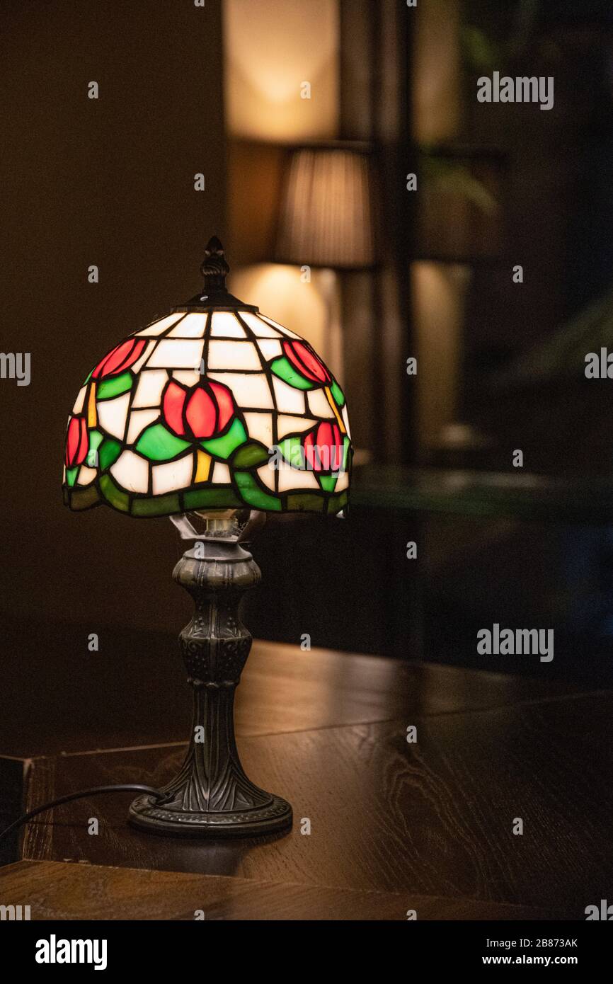 Stained Glass Lampshade With Floral Pattern Closeup On Dark Blurred Background Shiny Mosaic Lamp Atop Wooden Table Surface Vintage Ornate Lamp Shade Stock Photo Alamy