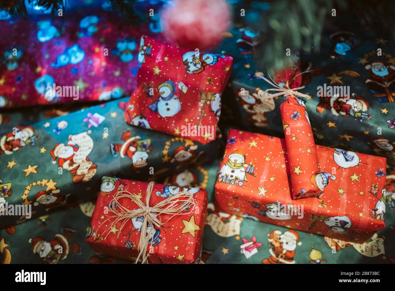 pile of colorful Christmas presents under the tree Stock Photo