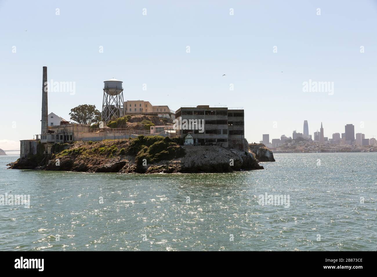 Alcatraz Island and prison with skyline of Downtown San Francisco in the distance behind. Stock Photo