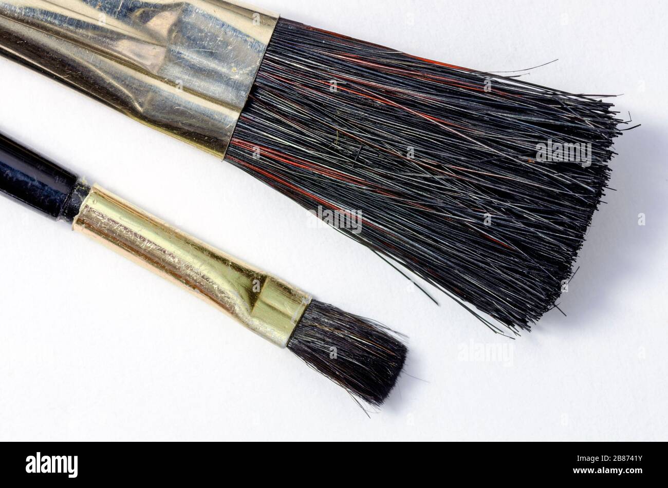 a small and a big brush with black hairs Stock Photo