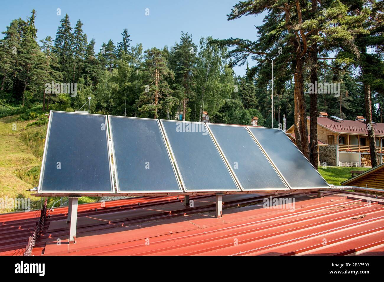Solar panel on a red roof Stock Photo - Alamy