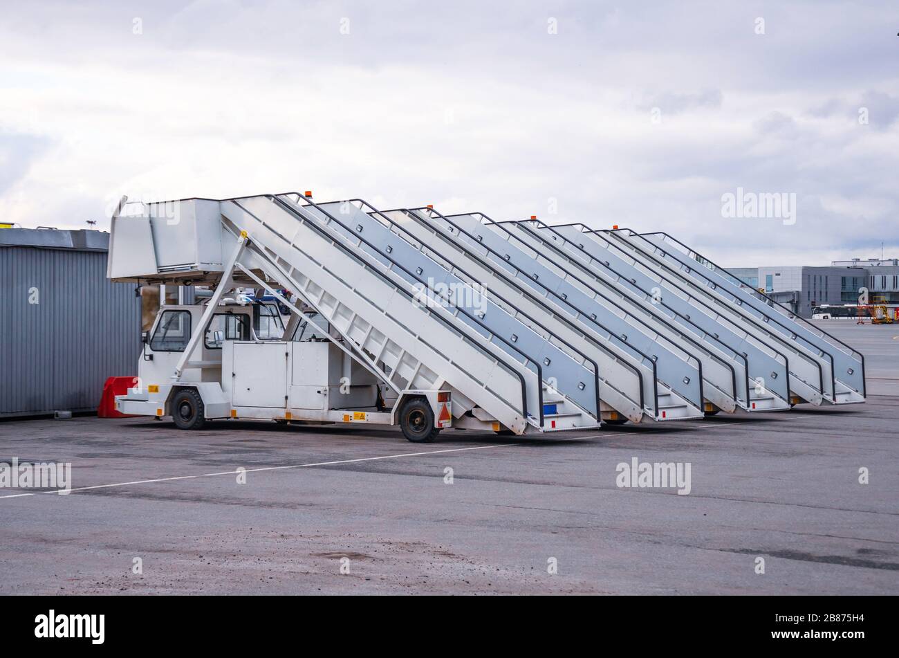 A row of gangways for boarding and alighting passengers from an airplane parked at the airport Stock Photo