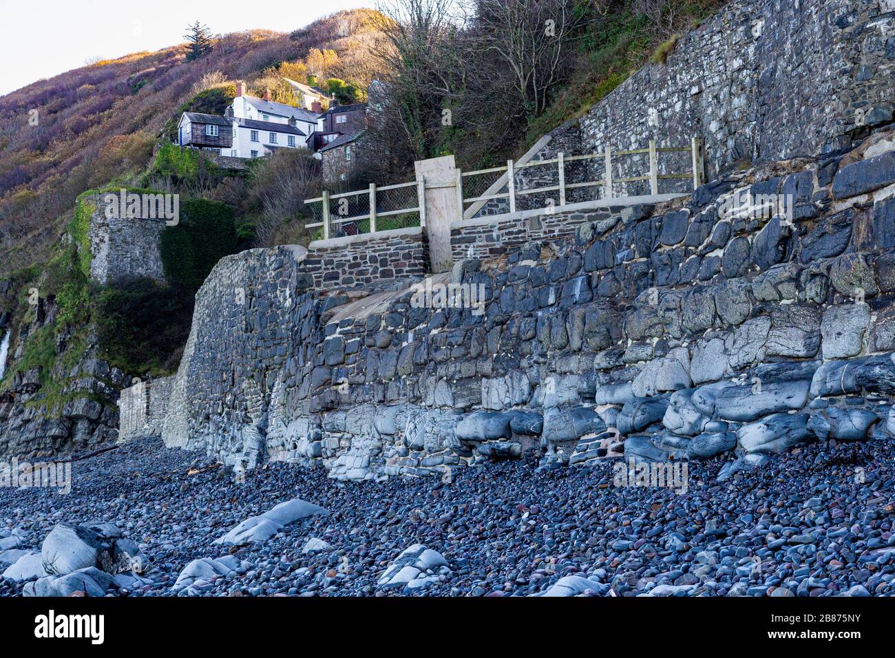 Bucks Mills Sea Wall and Lime Kiln View. Looking Inland with Cliff Top Houses and Detailed Defensive Stonework, on the North Devon Coast. Stock Photo