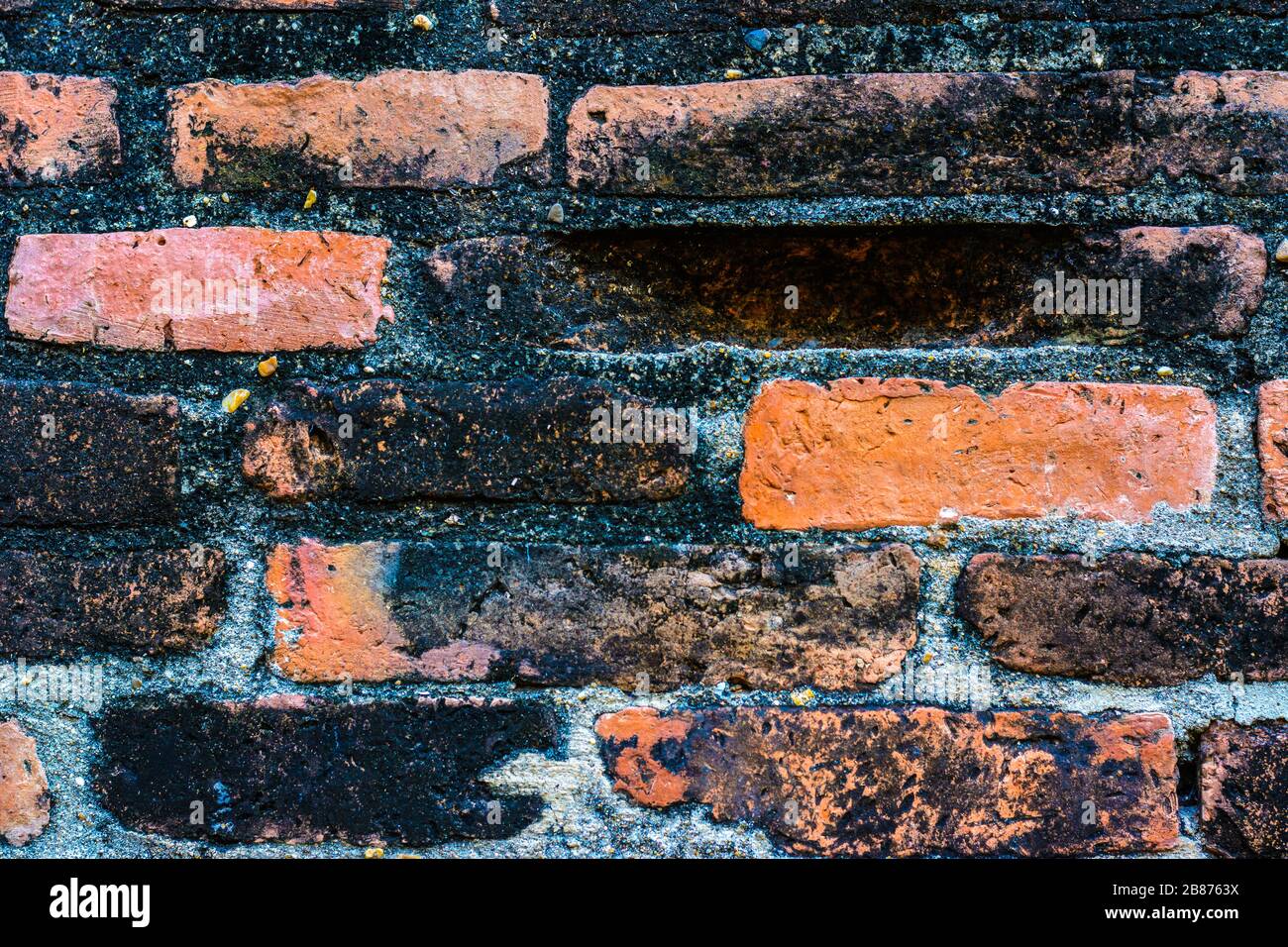 Old vintage brick wall in Lopburi, Thailand. Weathered brick wall texture background at old temple. Stock Photo