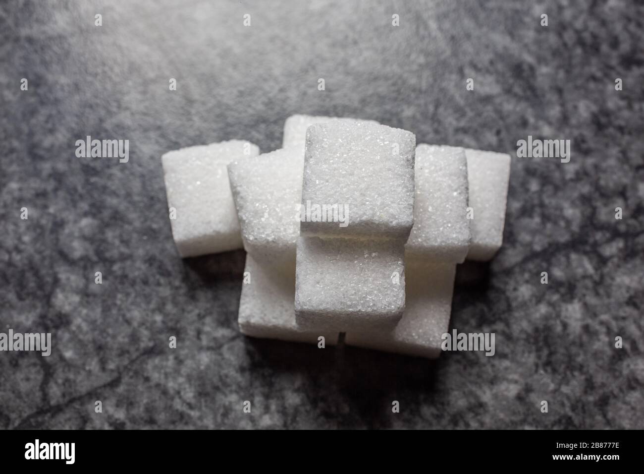 Sugar cubes stacked in a pile Stock Photo