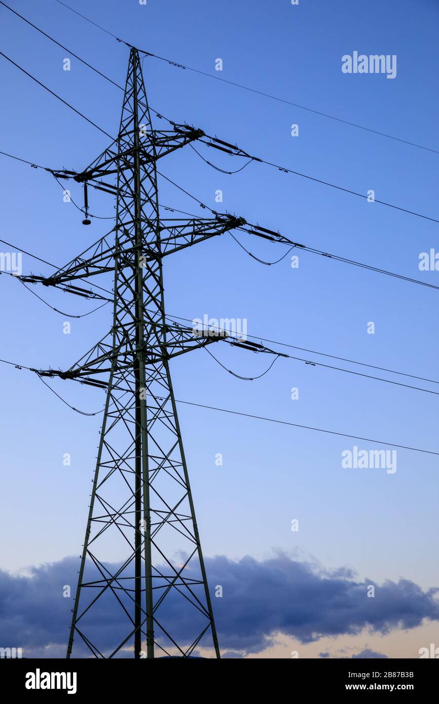High voltage power lines with electricity pylons at twilight Stock ...