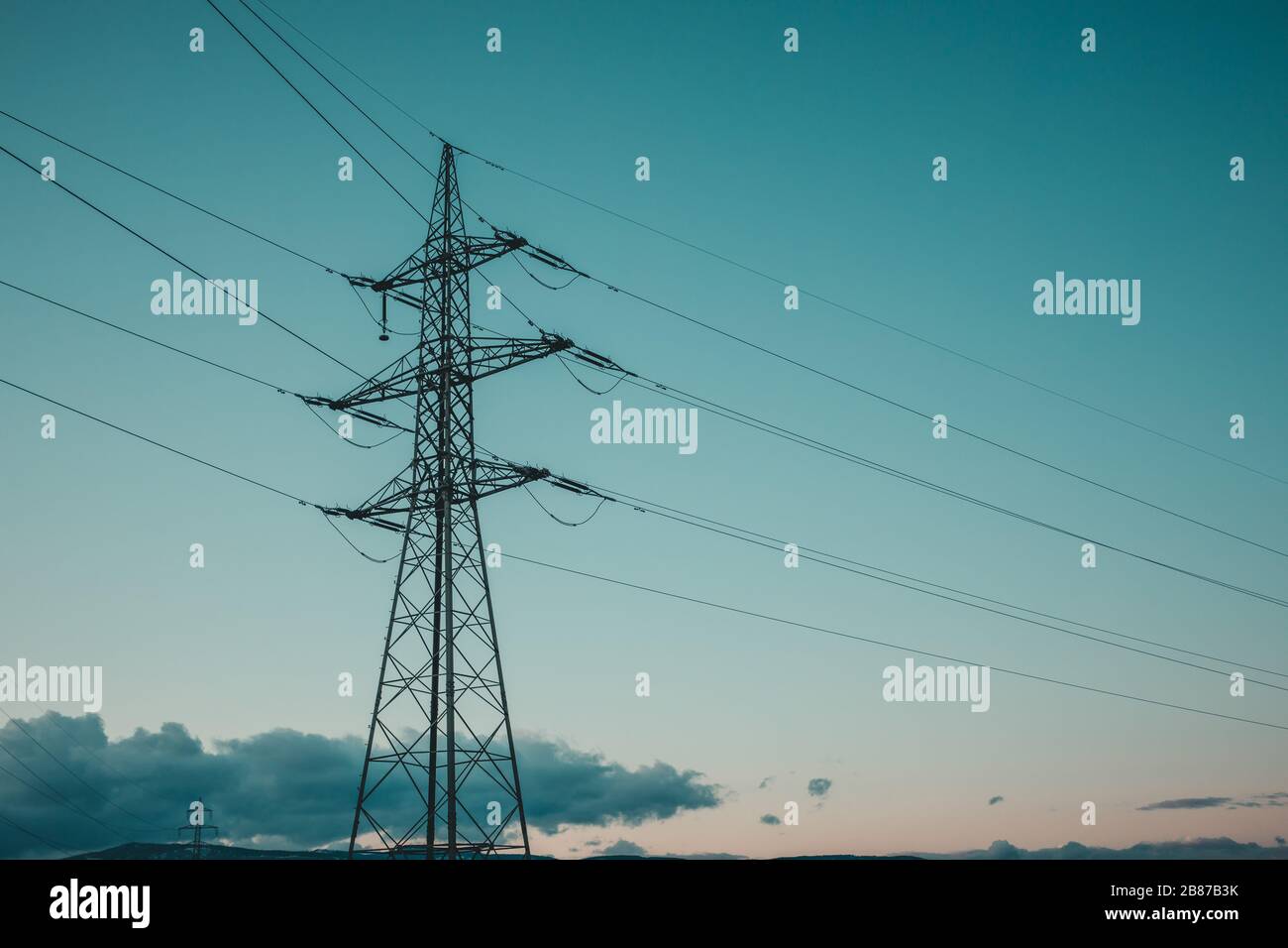High voltage power lines with electricity pylons at twilight Stock ...