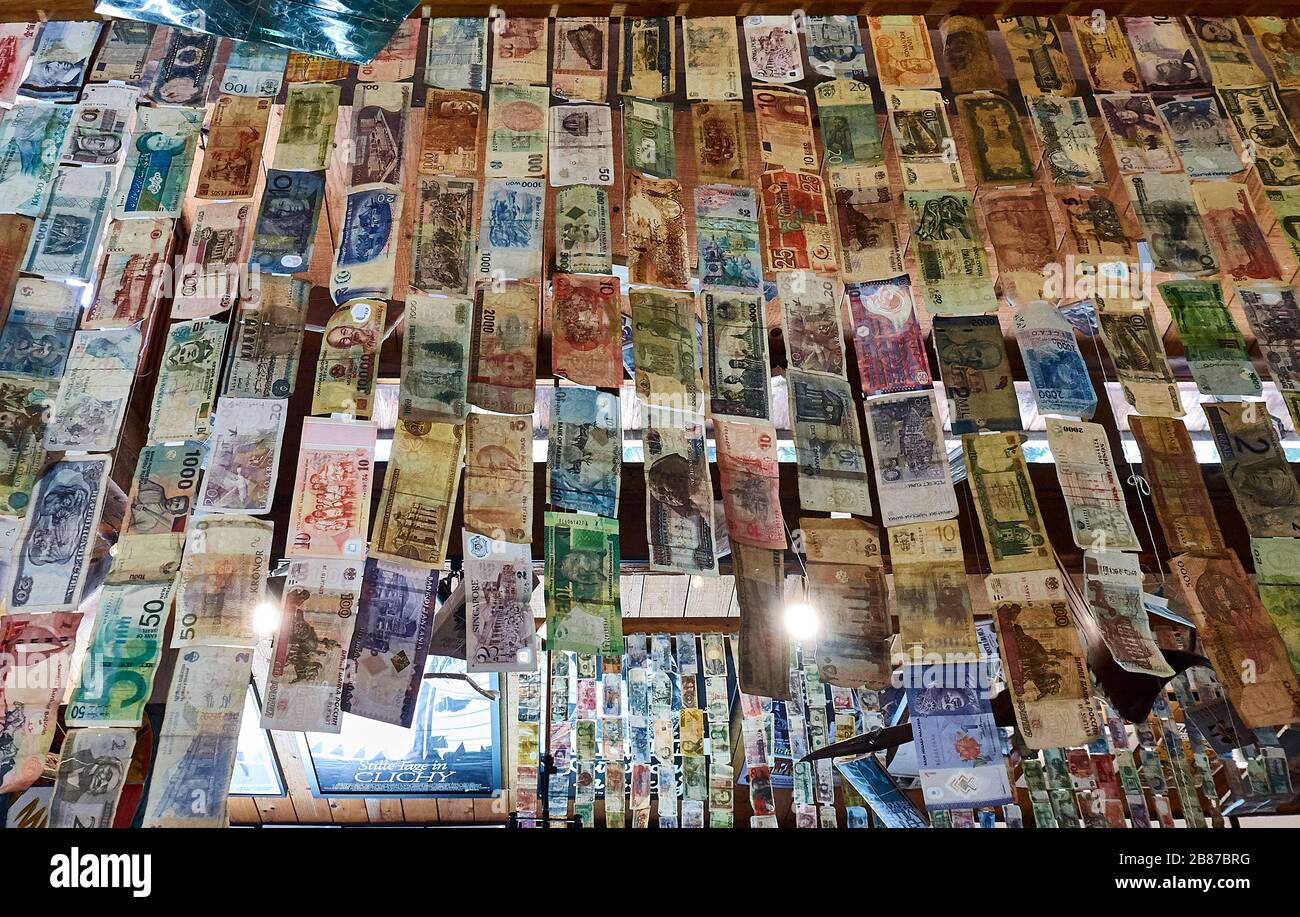 Banknotes from all-around the world are growing down from the ceiling of the Henry Miller Memorial Library. Stock Photo
