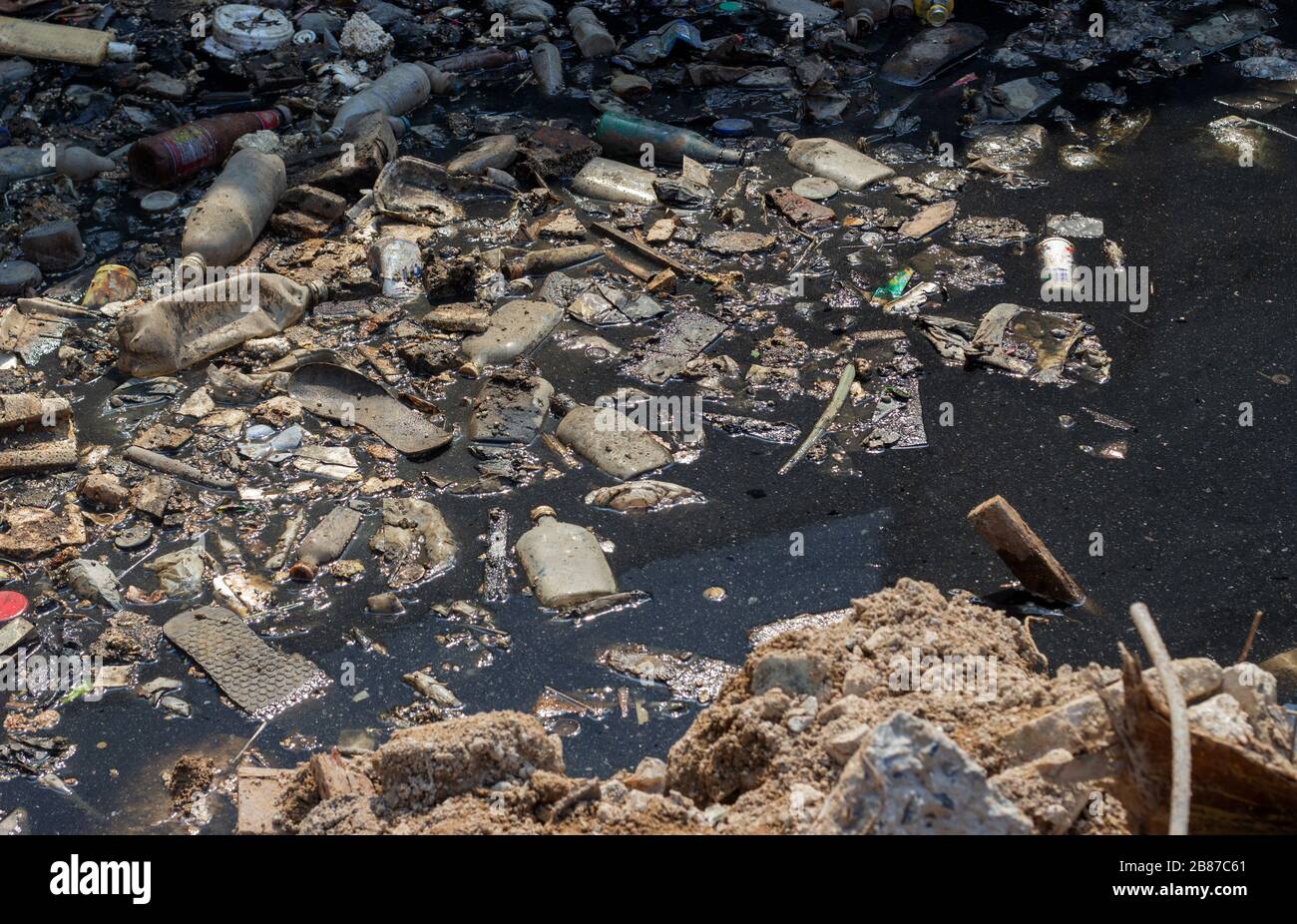 lot of rubbish on toxic pond to making bad environment on earth in