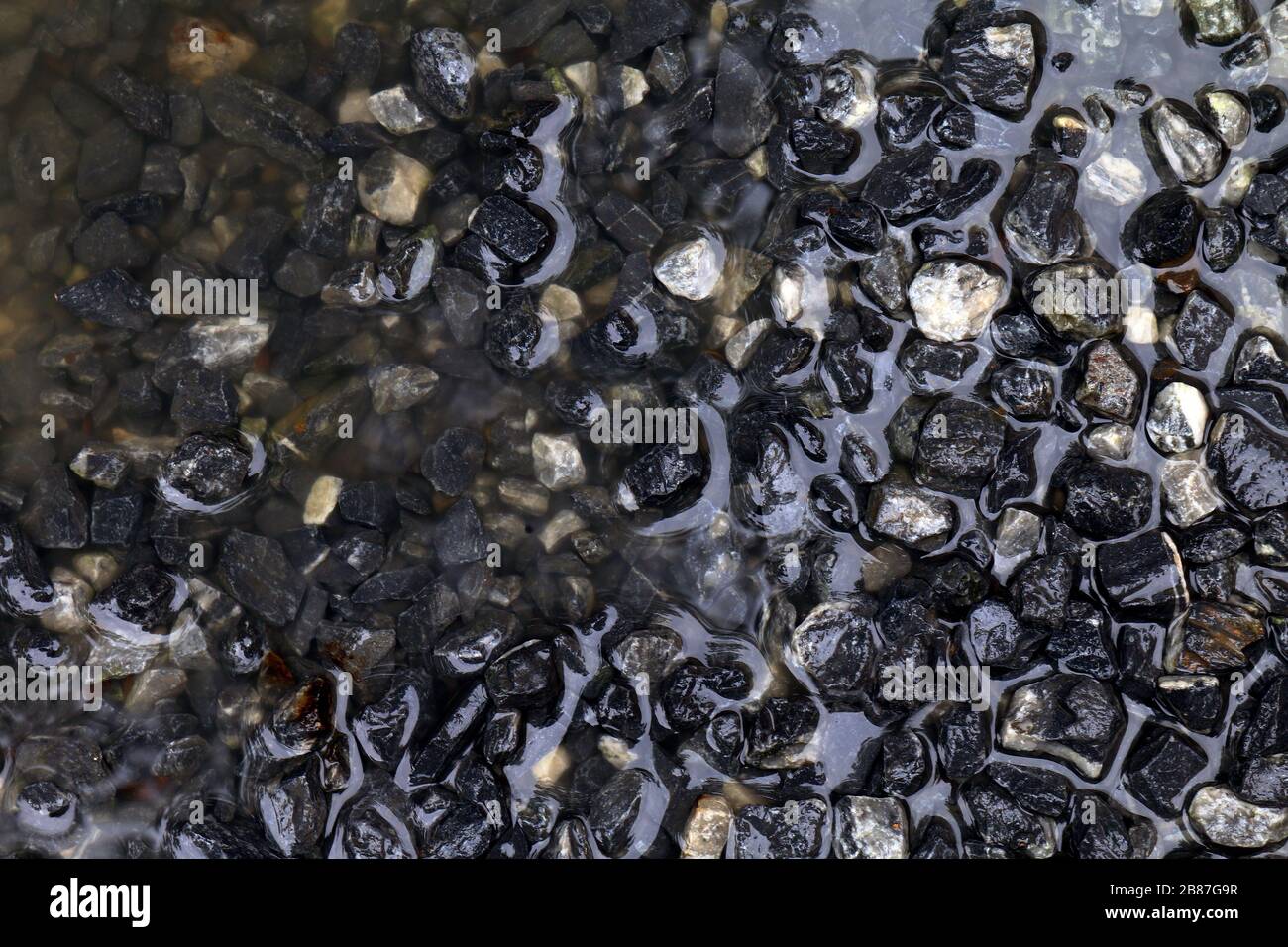 Stone wet for construction, wet Stone blue dark background, Rocks wet water for construction work Stock Photo
