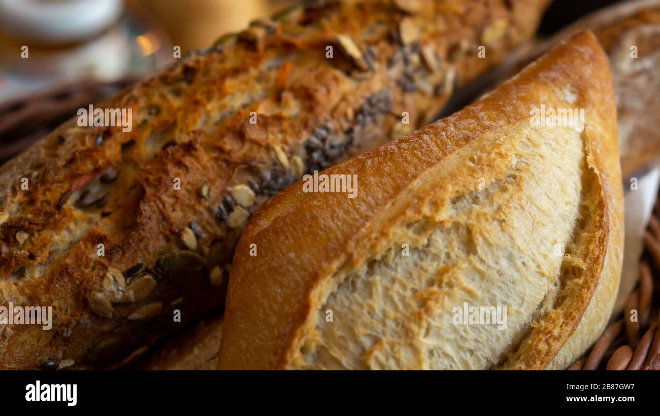 Different breads in a basket. Fresh Bakery with seeds and white bread