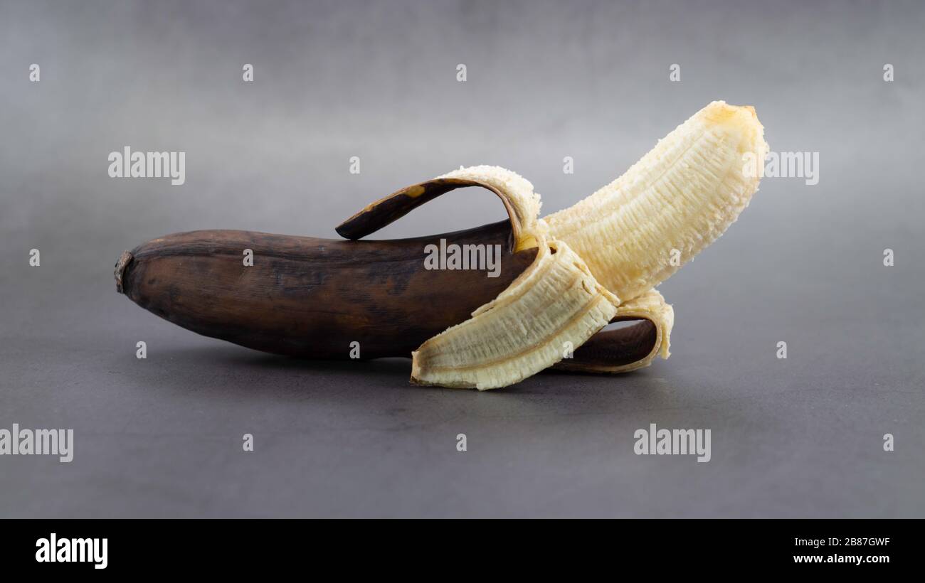 Concept of inner beauty. Ripe banana from outside but healthy and fresh inside background. Beautiful is inside the people. Appearance can be deceptive Stock Photo