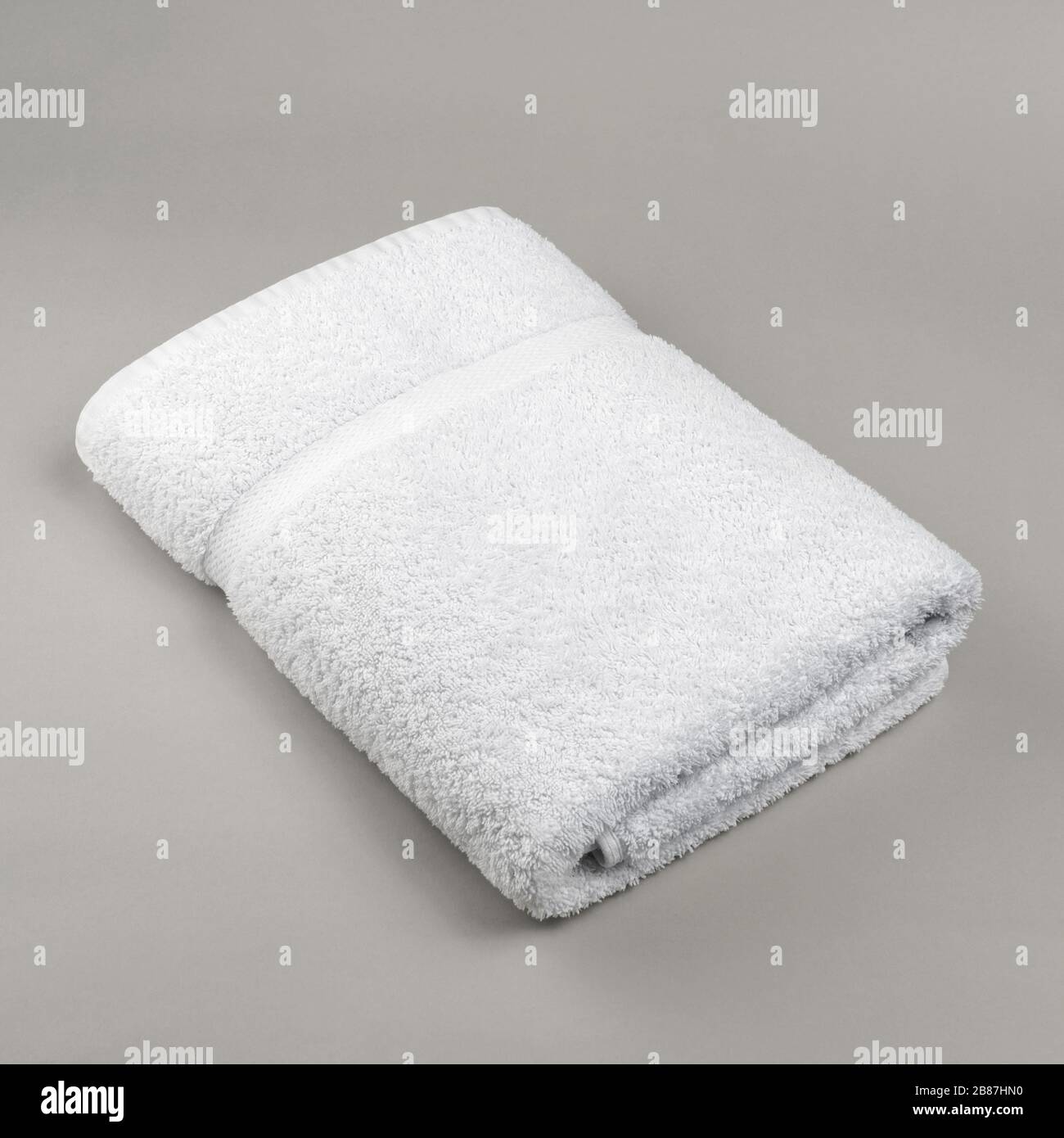 https://c8.alamy.com/comp/2B87HN0/neat-folded-fluffy-fresh-white-towel-on-gray-background-top-view-2B87HN0.jpg