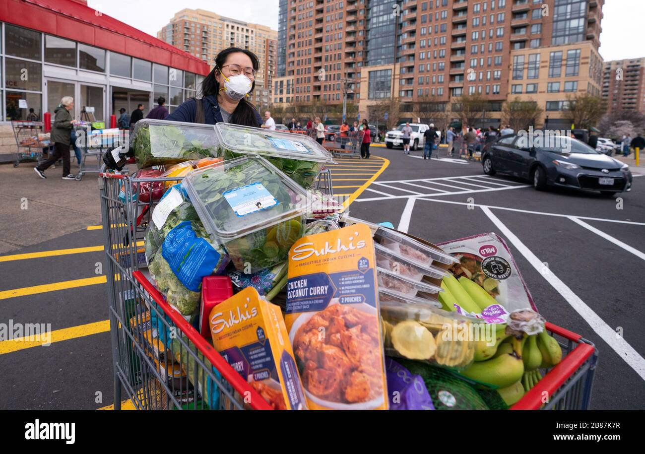 Alexandira, United States. 20th Mar, 2020. A shopper leaves a Costco Warehouse in Alexandria, Virginia on March 20, 2020. Shoppers are contenting to buy and bulk as the COVID-19, coronavirus, pandemic continues to expand in the United States. Photo by Kevin Dietsch/UPI Credit: UPI/Alamy Live News Stock Photo