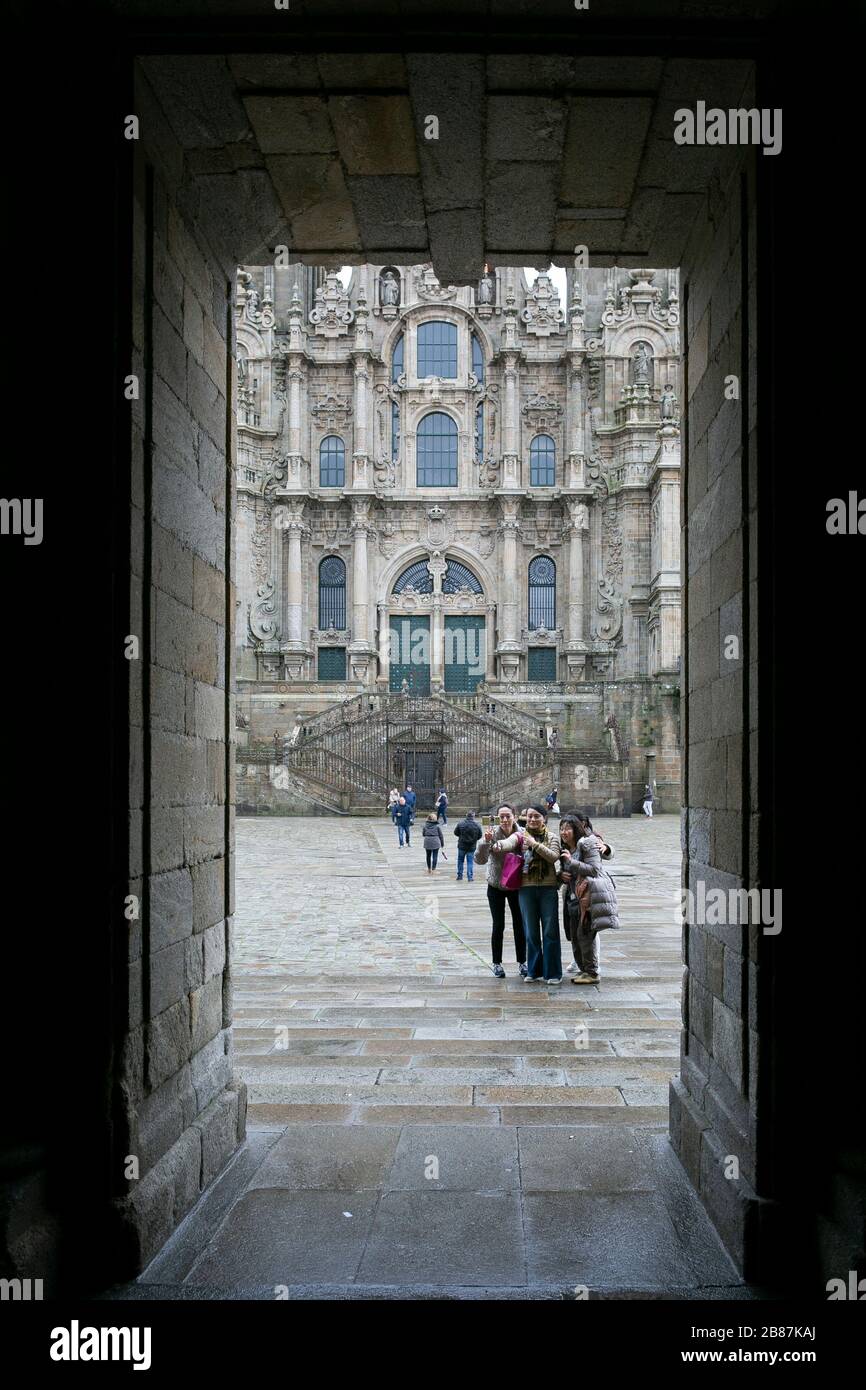Chinese tourists taking a selfie infront of the Santiago de Compostela's Cathedral. Obradoiro square . Galizia, Spain. Stock Photo