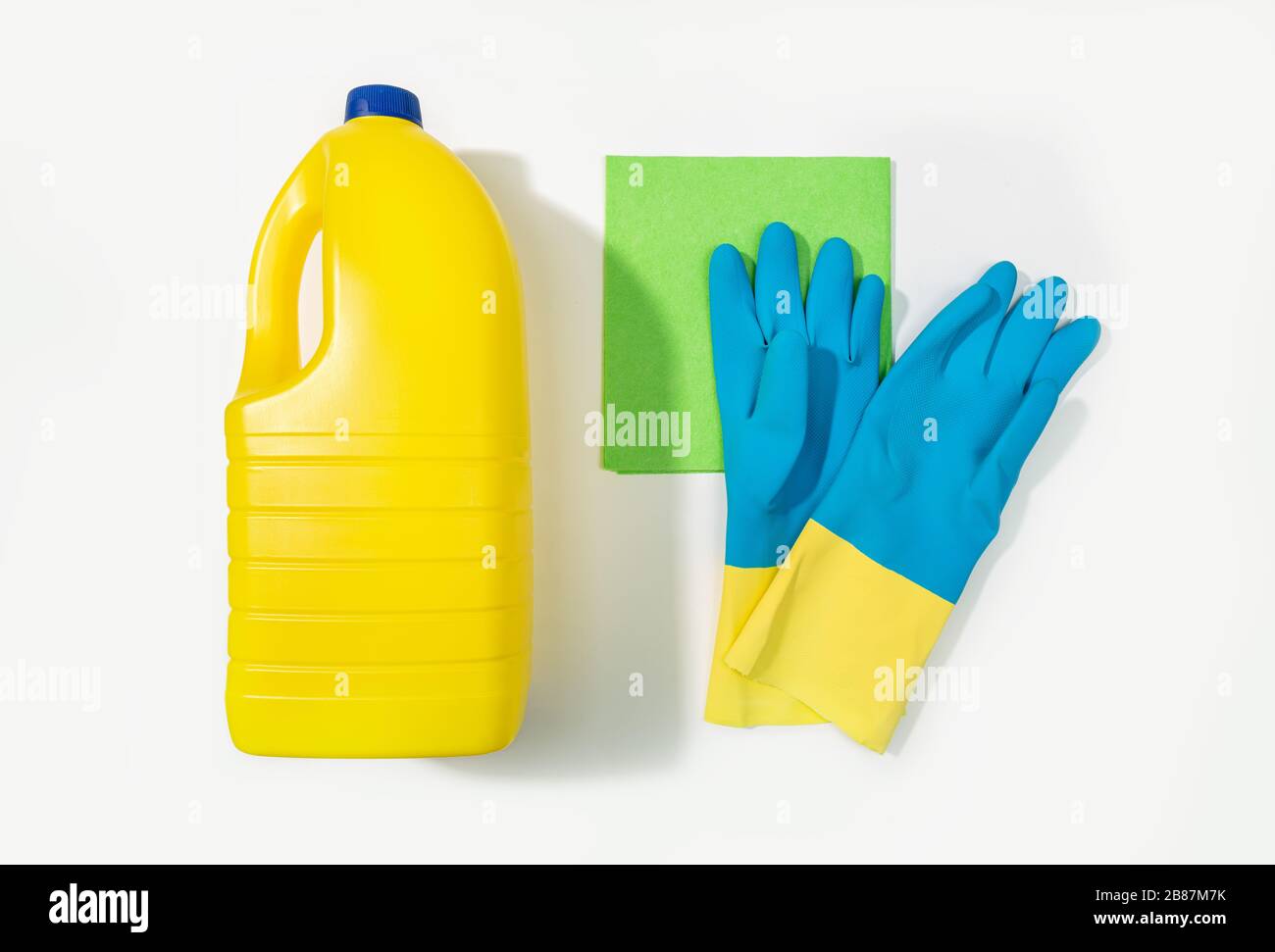 Bleach bottle, protective gloves and rag. Cleaning concept. Top view Stock Photo
