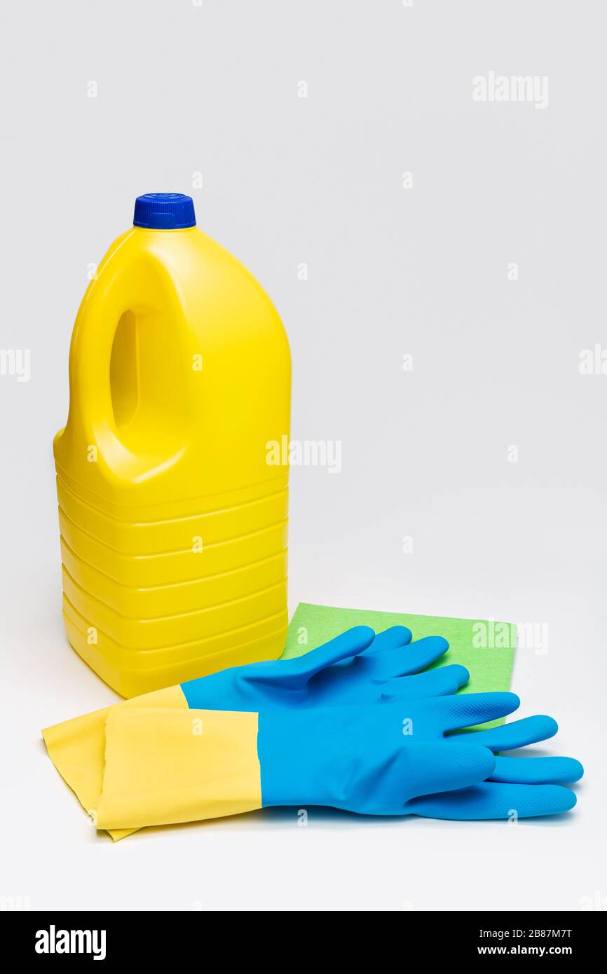 Bleach bottle, protective gloves and rag. Cleaning concept. Copy space Stock Photo