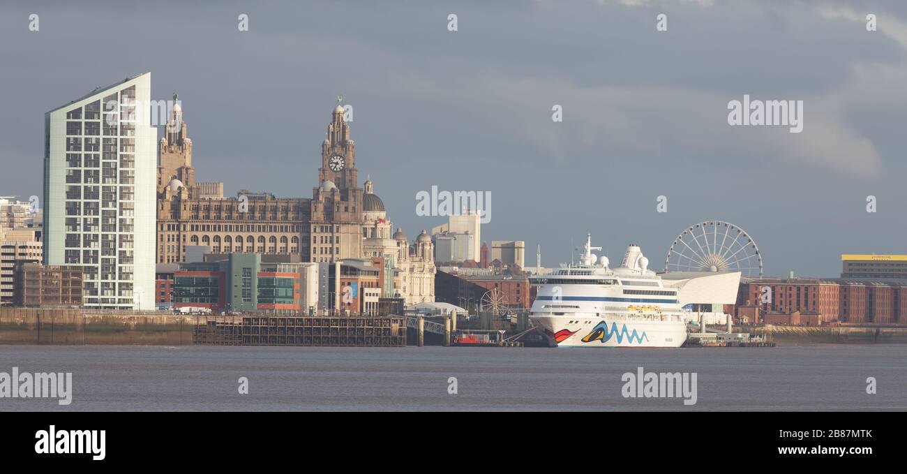 The cruise ship AIDAvita berthed at Liverpool Cruise Terminal, alongside the Three Graces, seen from near New Brighton Stock Photo