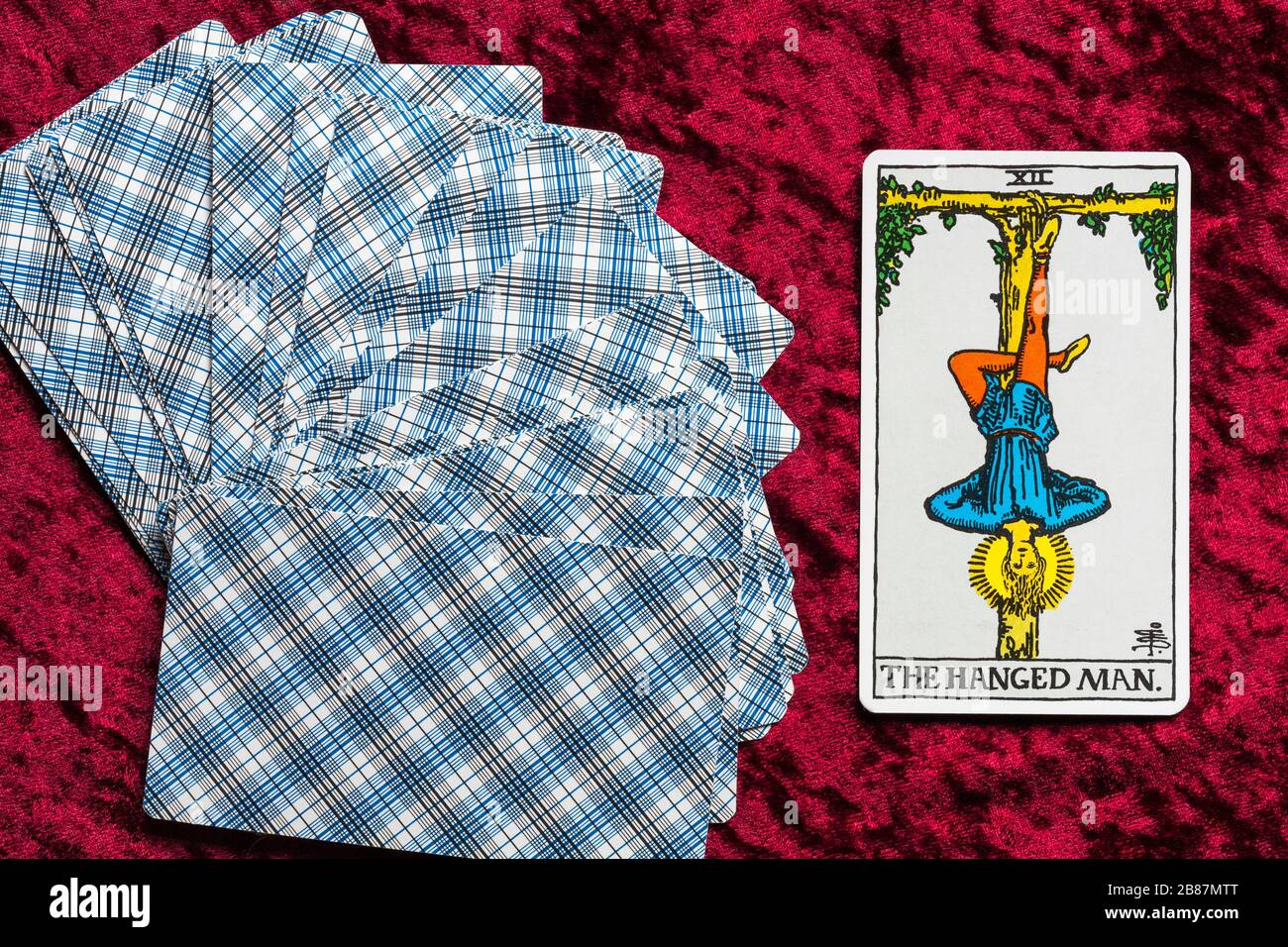 Rider Tarot Cards designed by Pamela Colman Smith under supervision of  Arthur Edward Waite fanned on red cloth with The Hanged Man tarot card  upturned Stock Photo - Alamy