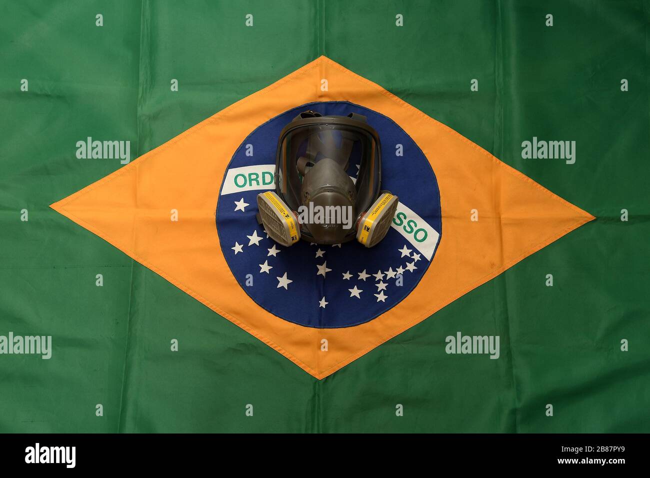 Rio de Janeiro, Brazil, March 20, 2020. Face protection mask against gases and odors with Brazilian flag in the background. Stock Photo