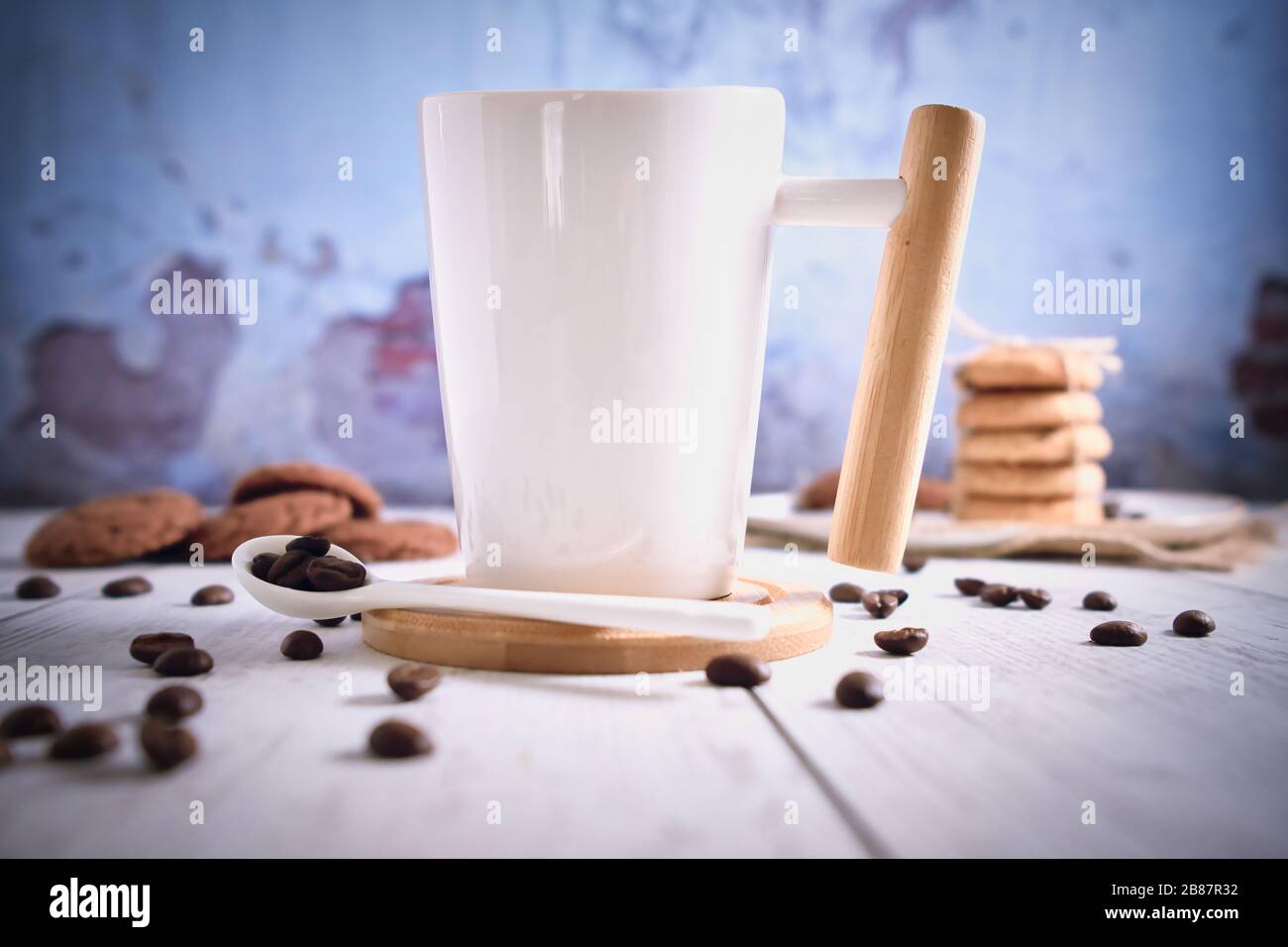 Roasted brown coffee beans and Hot coffee. Beautifully stacked cookies with chocolate on Wooden table. Chocolate chip cookies Vintage Color. Stock Photo