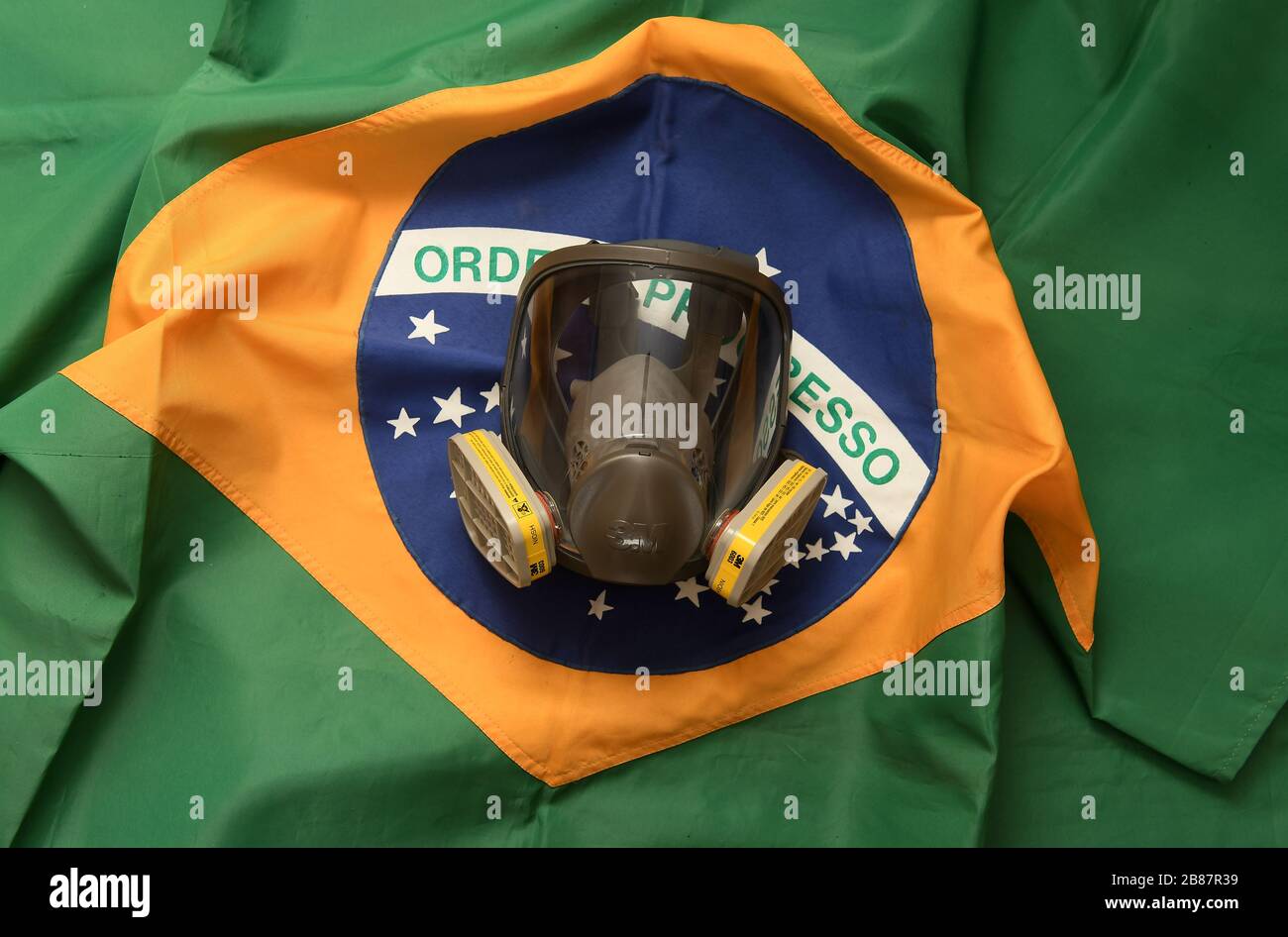 Rio de Janeiro, Brazil, March 20, 2020. Face protection mask against gases and odors with Brazilian flag in the background. Stock Photo