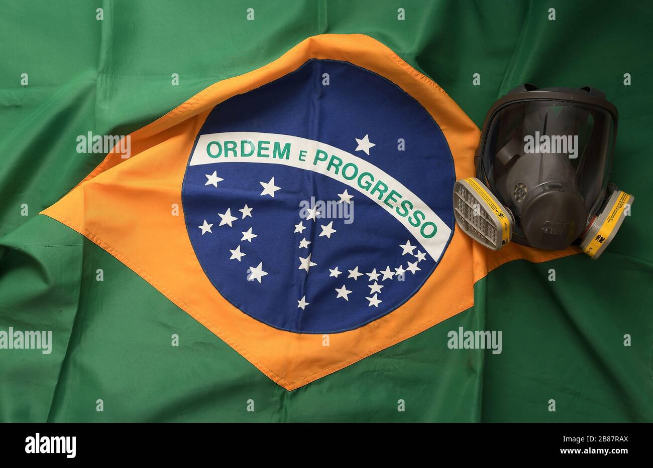 Rio de Janeiro, Brazil, March 20, 2020. Face protection mask against gases and odors with Brazilian flag in the background. Stock Photo
