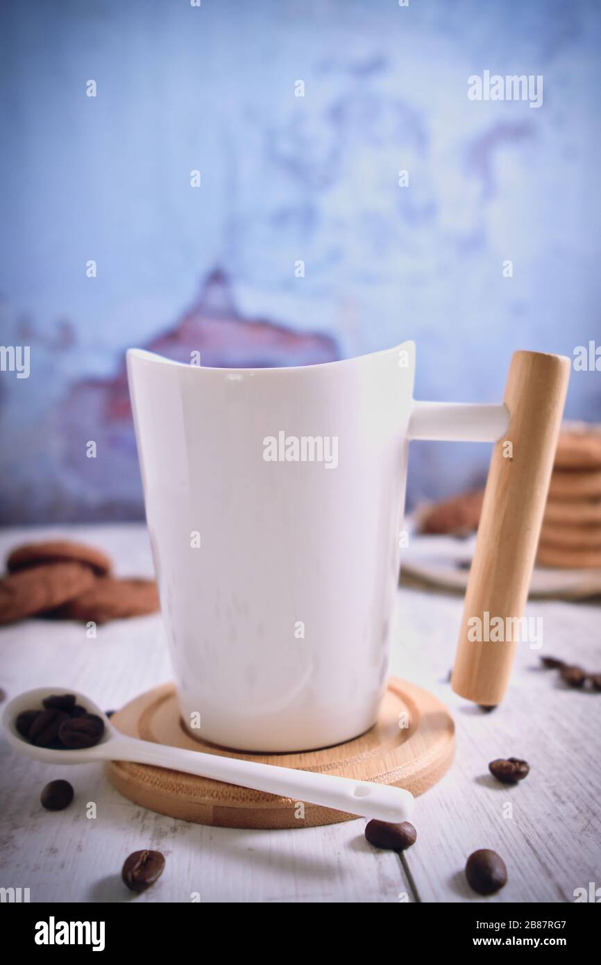 Roasted brown coffee beans and Hot coffee. Beautifully stacked cookies with chocolate on Wooden table. Chocolate chip cookies Vintage Color. Stock Photo