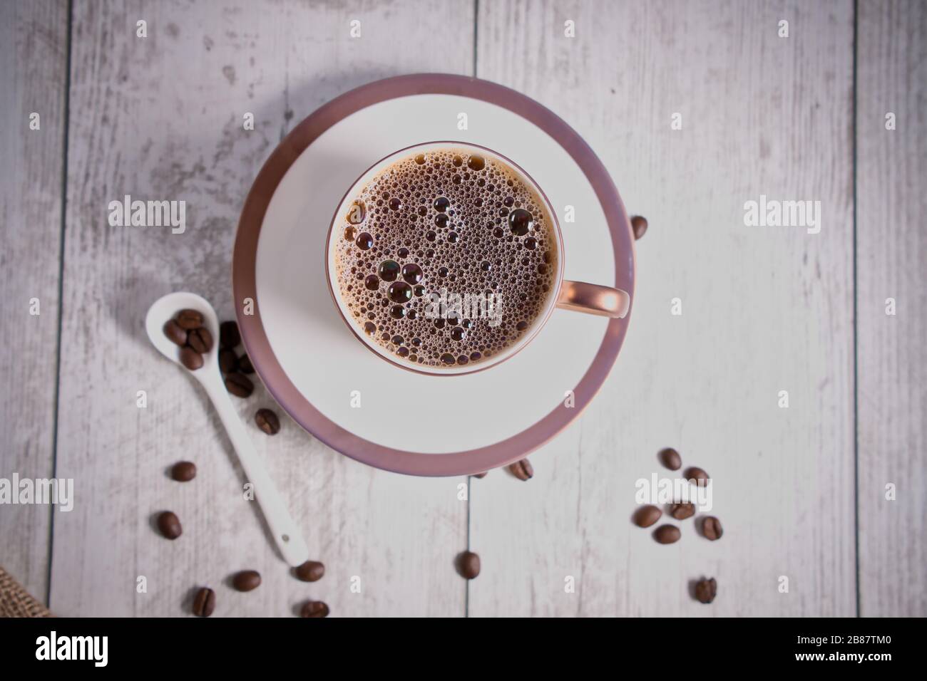 Roasted brown coffee beans and Hot coffee. Beautifully stacked cookies with chocolate on Wooden table. Chocolate chip cookies Vintage Color. Stock Photo