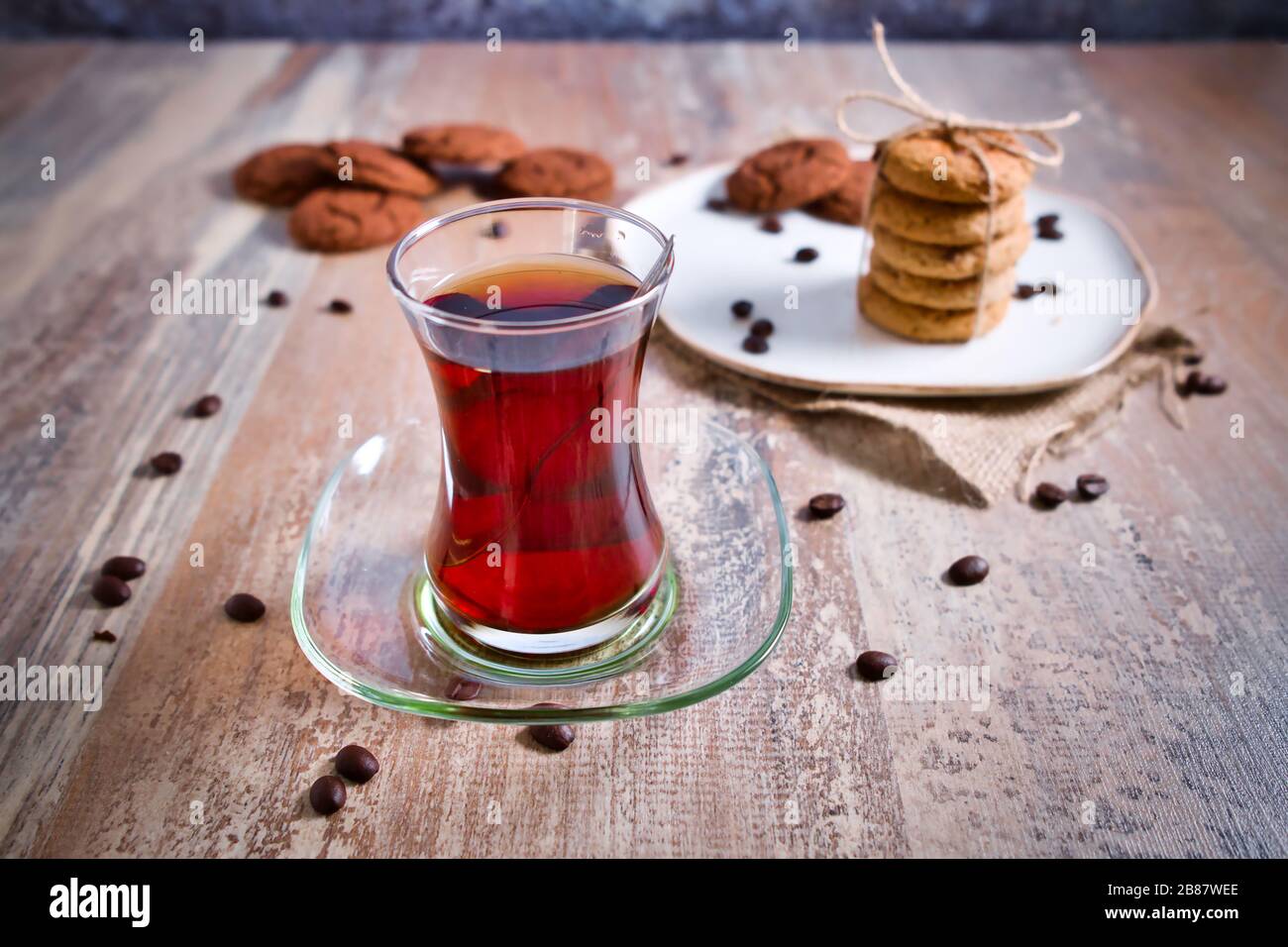 Beautifully stacked cookies with chocolate on Wooden table. Chocolate chip cookies Vintage Color. Traditional Turkish Tea. Stock Photo
