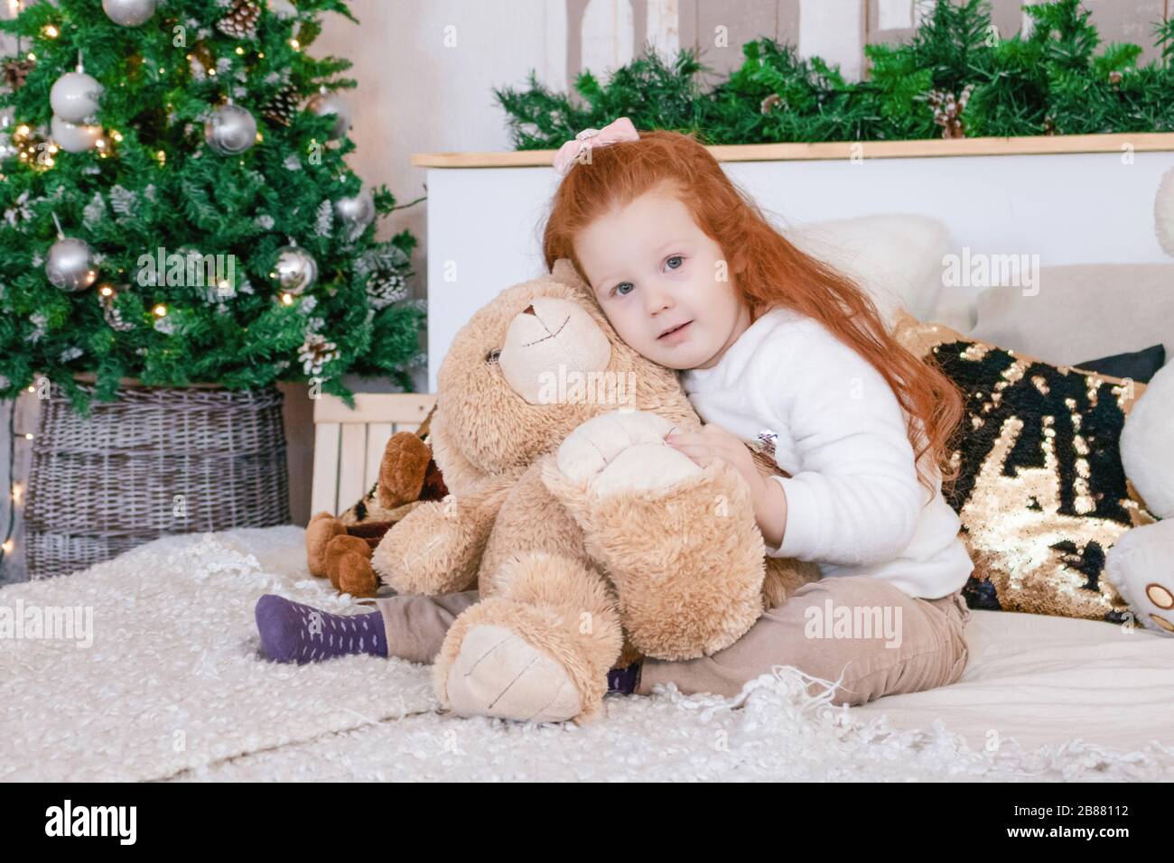 little girl hug bear at christmas photo Stock Photo