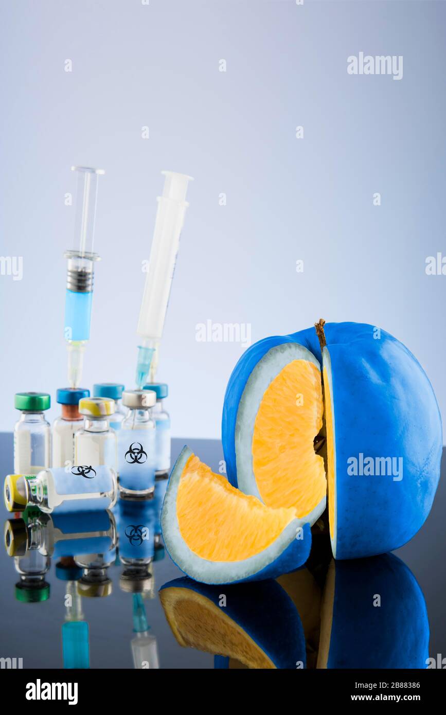 Digital Composing, Genetically manipulated fruit with syringes and vials, symbol picture genetic manipulation, Austria Stock Photo