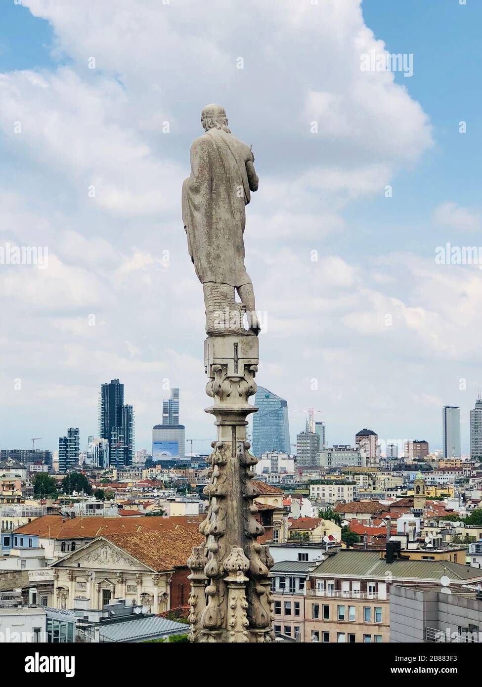 Statue on the top of Duomo dI Milano.Pray for Italy . Defocused photo Stock Photo
