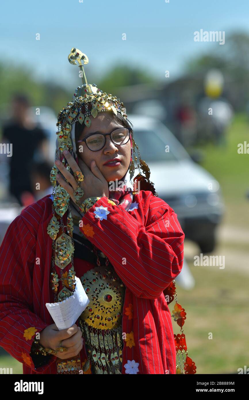 TURKMENISTAN, ASHGABAT - MAY 1, 2019: Day of turkmen racehorse. Public. Girl in a traditional clothes and head decoration. Stock Photo