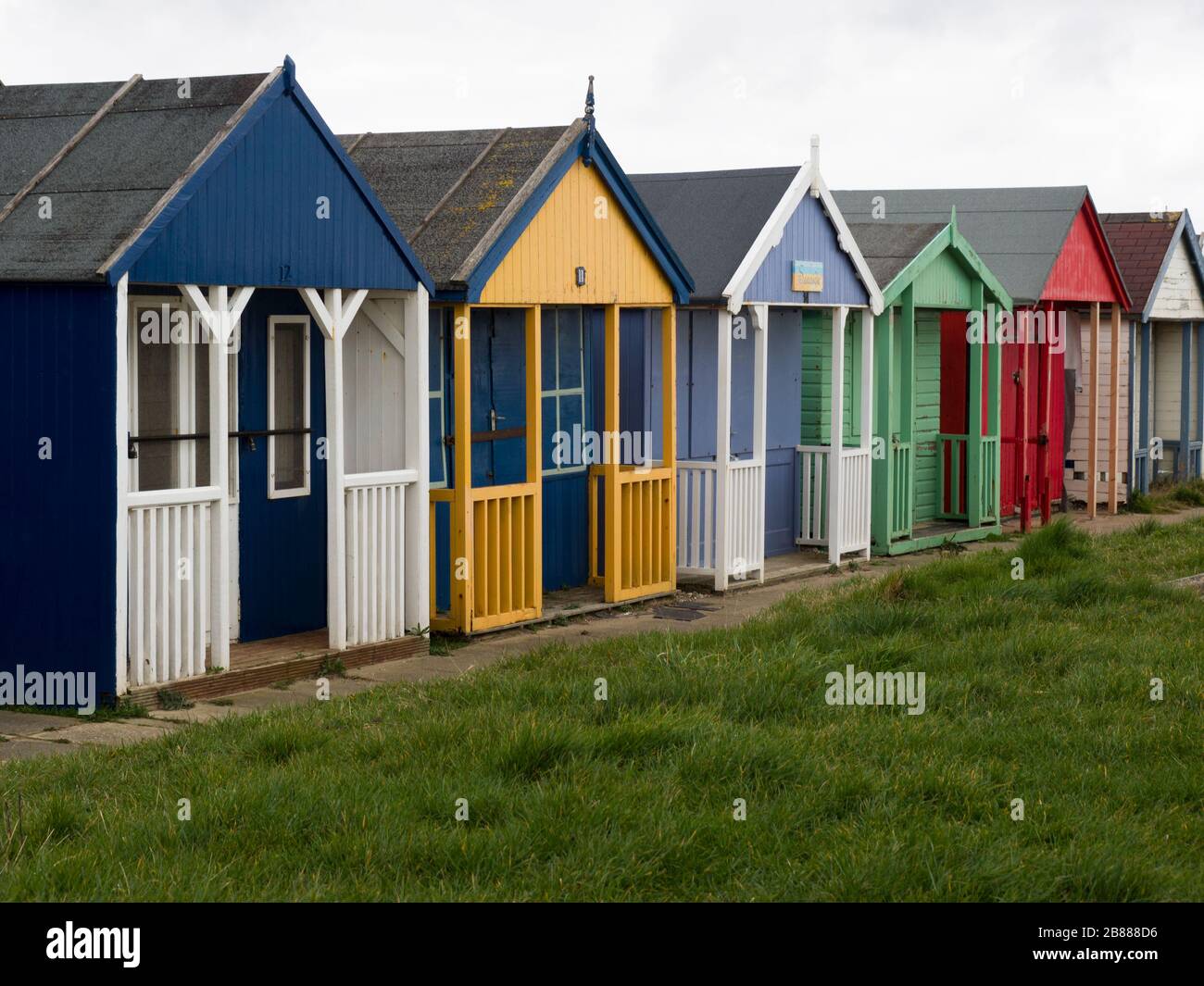 Beach huts along the promenade between Sandilands and Maplethorpe, Lincolnshire, UK Stock Photo