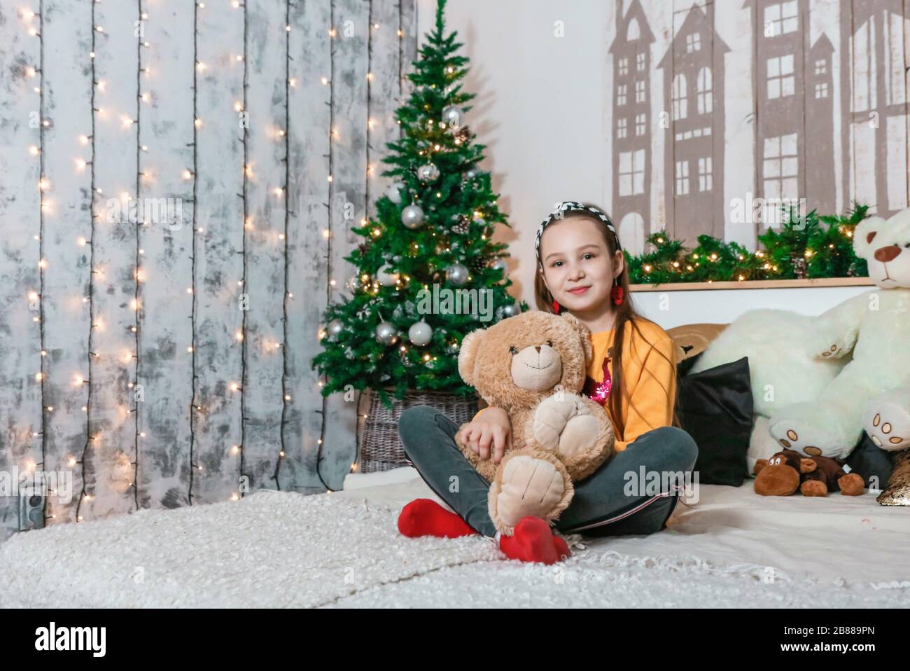 little girl hug bear at christmas photo Stock Photo