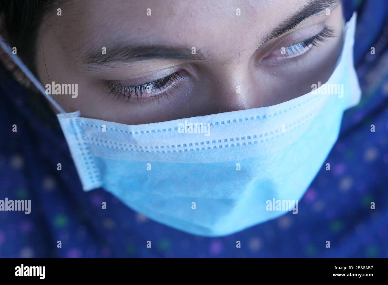 young woman in medical face protection mask indoors Stock Photo