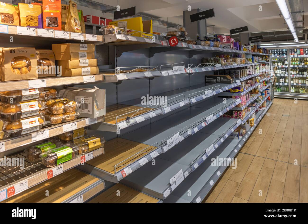 Empty bread shelves in a Cooperative supermarket in Woking, Surrey southeast England emptied by panic buying due to Coronavirus Stock Photo