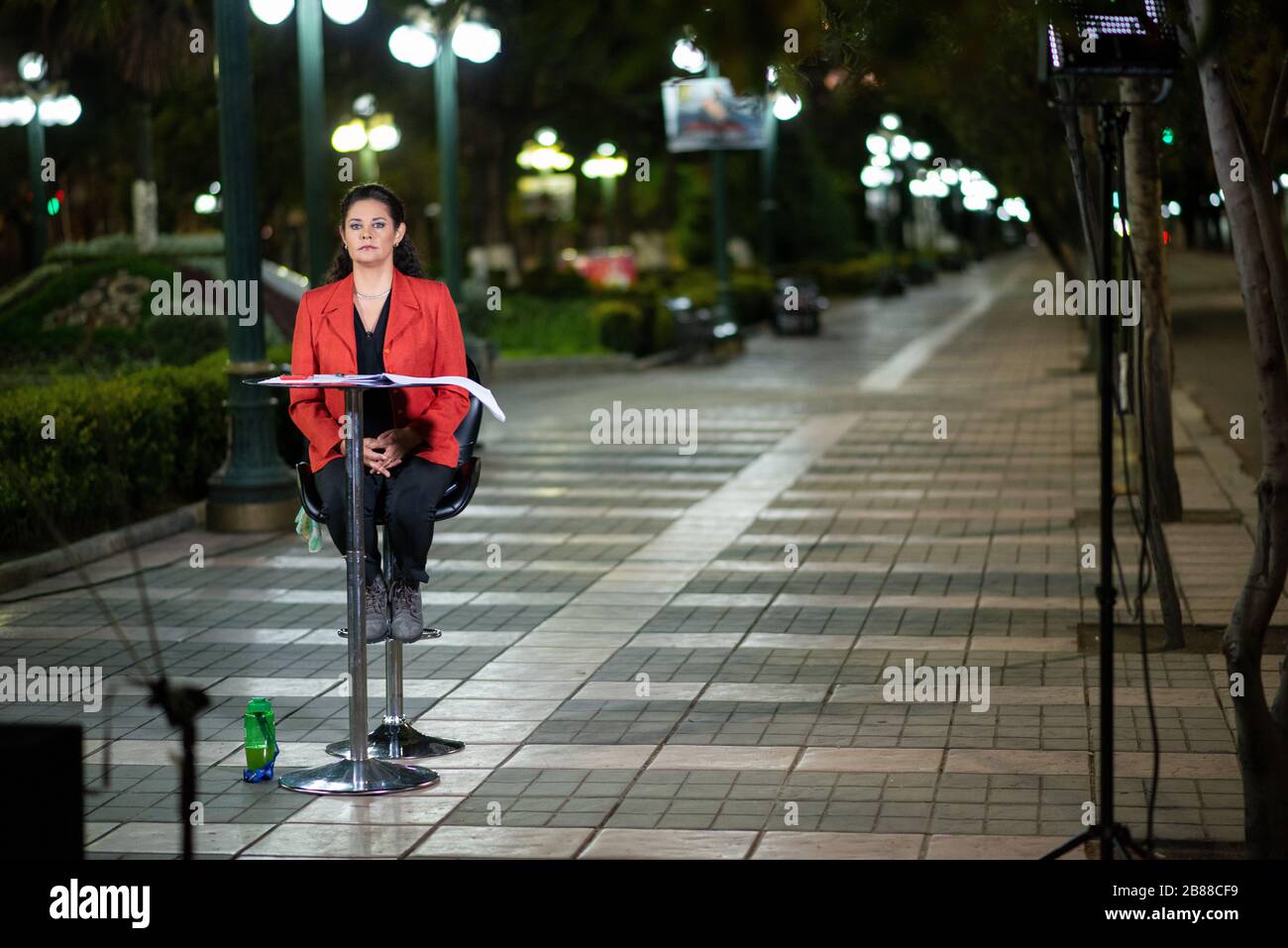 La Paz, Bolivia. 19th Mar 2020. Bolivian TV anchor Veronica Paniagua prepares for going live -  with the main avenue of Bolivia’s seat of government, commonly known as El Prado, completely abandoned in the background. With 15 confirmed cases of the corona virus, Bolivia introduced a nationwide quarantine on 18th Mar 2020. Citizens aren’t allowed in the streets after 6 p.m. Radoslaw Czajkowski, Alamy Live News Stock Photo