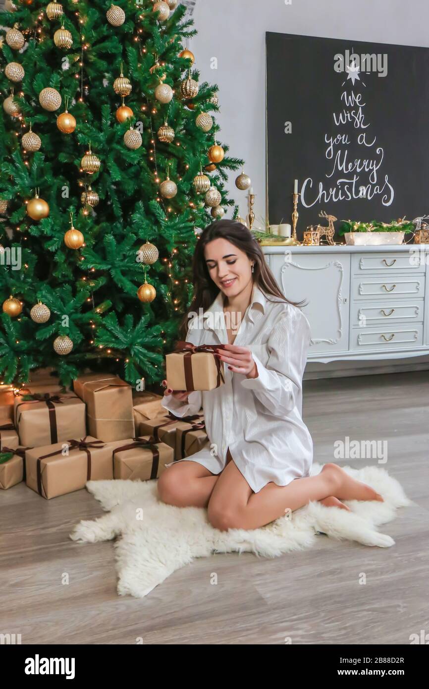 happy girl opening Christmas presents at home photo Stock Photo