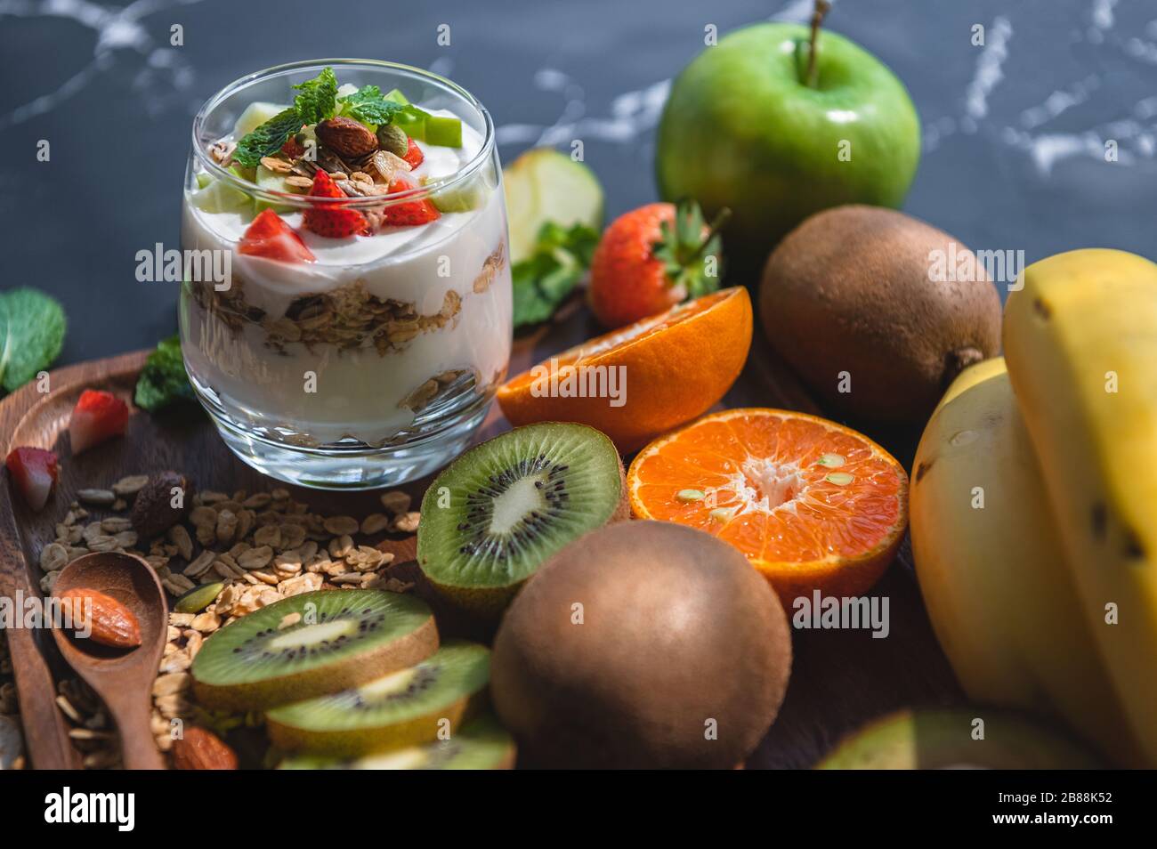 Closeup nutrition yogurt with many fruits on table. Food cuisine and ...