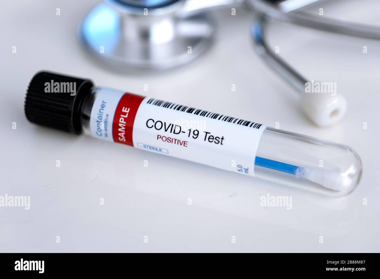 Testing for presence of coronavirus. Tube containing a swab sample for COVID-19 that has tested positive. Stock Photo