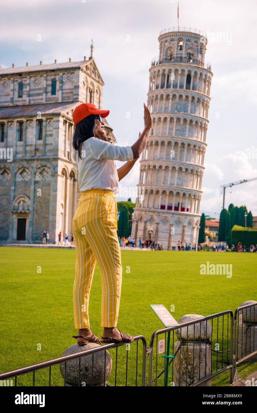 woman visit pisa tower, Leaning tower of Pisa, Italy with Basilica and Cathedral on a bright summer day  Stock Photo