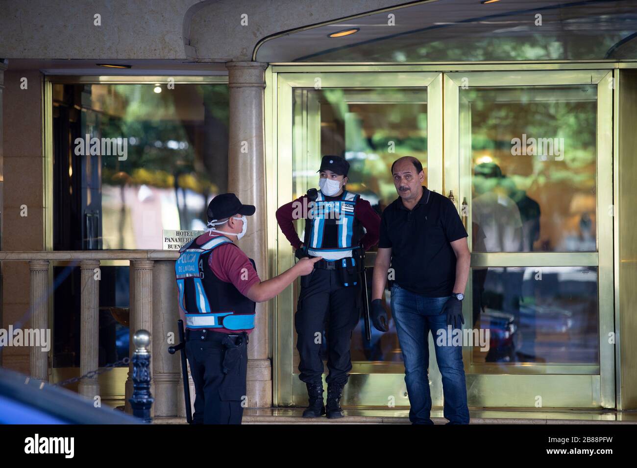 Buenos Aires, Argentina - March 20, 2020: Police officers wearing masks in the hotel where 400 people is held in quarentine after travel from uruguay Stock Photo