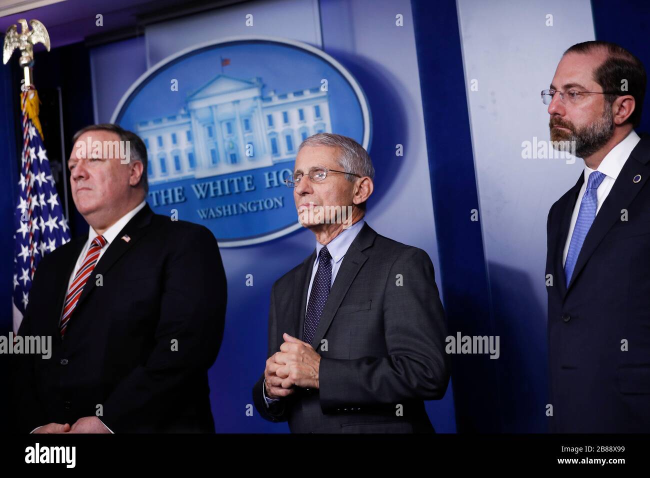 United States Secretary of State Mike Pompeo, from right, Director of the National Institute of Allergy and Infectious Diseases at the National Institutes of Health Dr. Anthony Fauci, and United States Secretary of Health and Human Services (HHS) Alex Azar, listen during a Coronavirus Task Force news conference in the briefing room of the White House in Washington DC, U.S., on Friday, March 20, 2020. Americans will have to practice social distancing for at least several more weeks to mitigate U.S. cases of Covid-19, Director of the National Institute of Allergy and Infectious Diseases at th Stock Photo