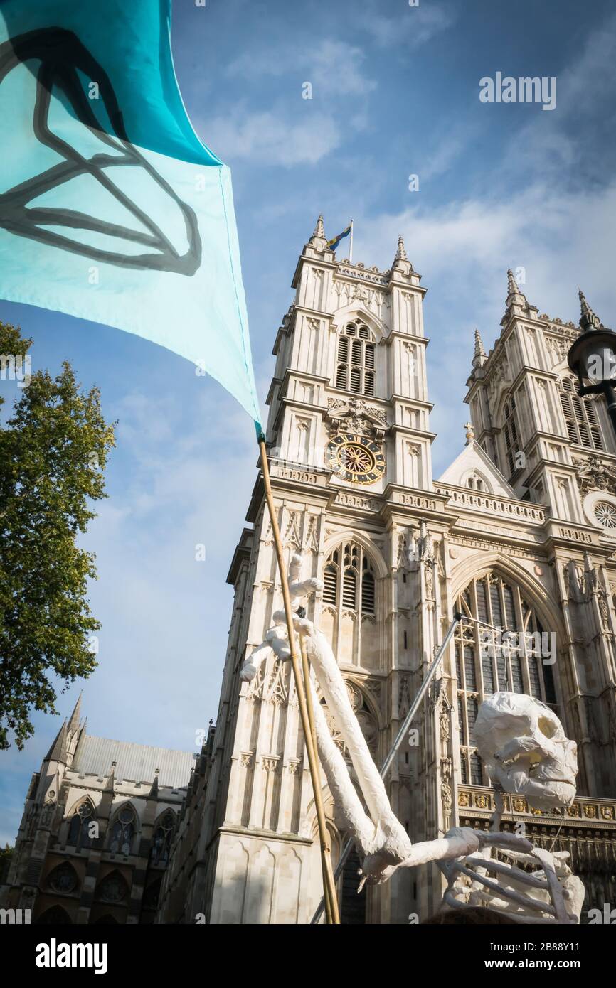 Westminster Abbey, London, UK - October 9, 2019- Extinction Rebellion climate change ptotests - a fake skeleton with a protesters' flag Stock Photo