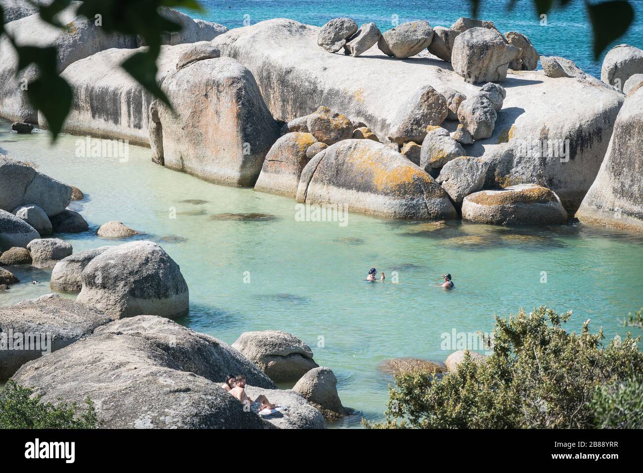 Cape Town, South Africa - Nowember 30, 2019 - tourists swimming on Boulders Beach near Simons Town Stock Photo