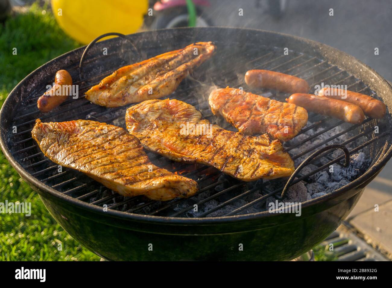 Meat on a charcoal grill at a barbecue Stock Photo - Alamy